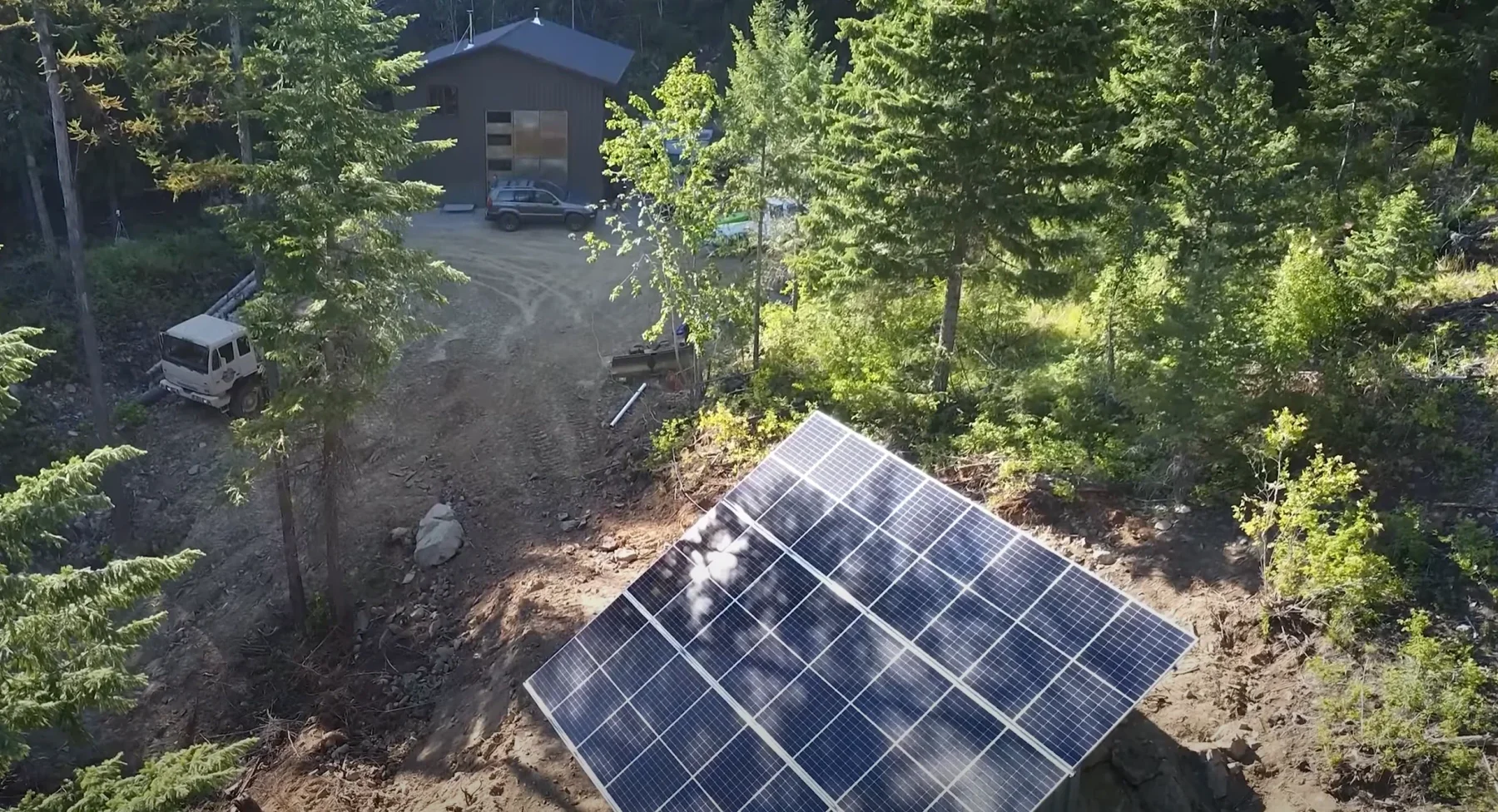 Ambition Strikes Solar array partially shaded by some trees in the afternoon