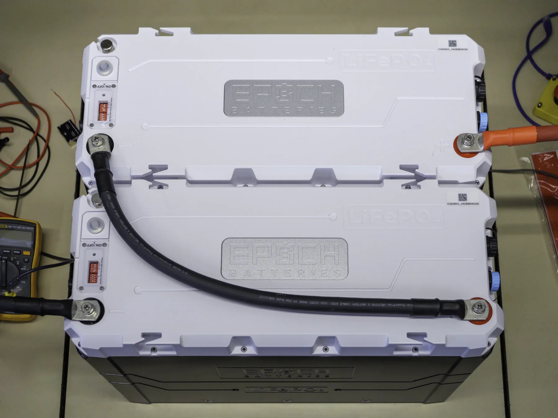 Photo of two Epoch 460Ah 12V batteries connected in series with 4/0 AWG cables forming a 24V 460Ah Batter bank