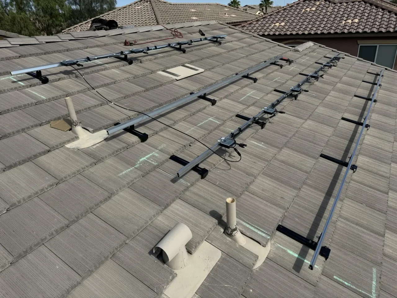 Finished view of the IntegraRack IR-T1 tile mounting brackets supporting Ironridge rails with the Microninverters added