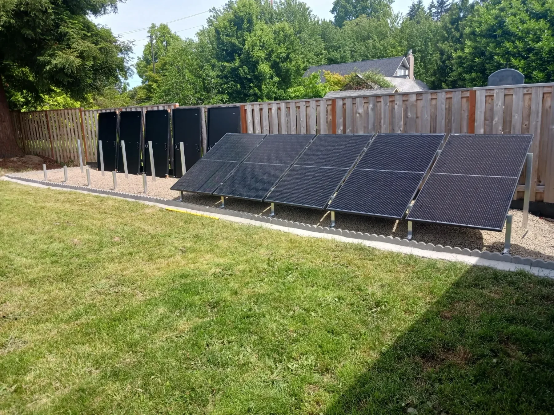 IntegraRack IR-30 solar panel mounting frames, half of array set up in a backyard